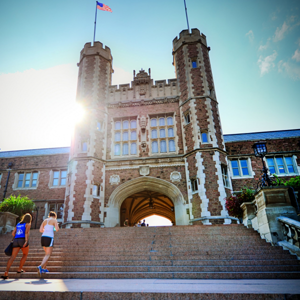 two students walking up the steps of brookings hall