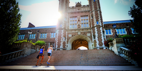 two students walking up the steps of brookings hall