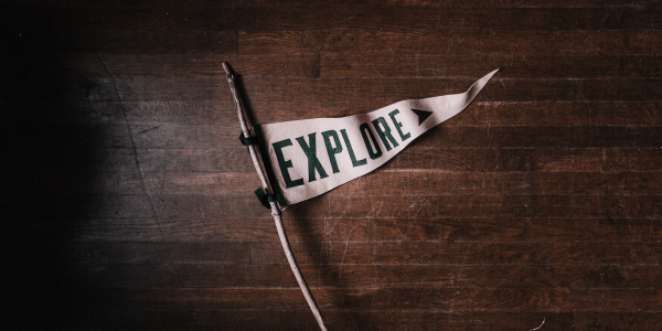white flag with the word explore written in bold dark letters
