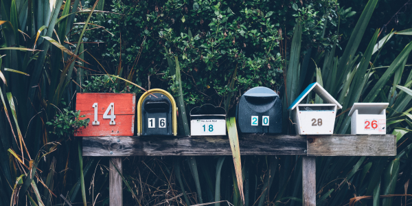 six multicolored mailboxes