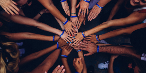 Group of people with hands together