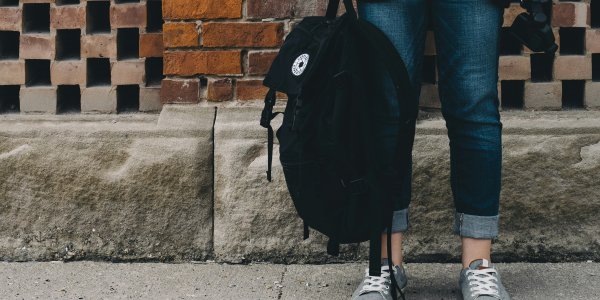 individual holding backpack