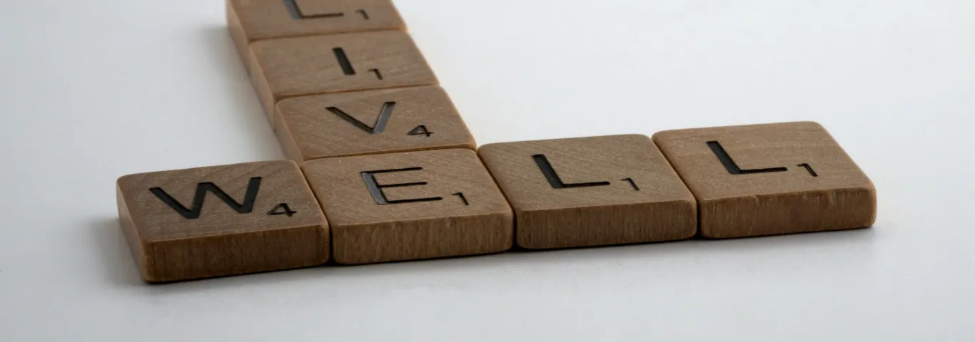 scrabble letters spelling out live and well