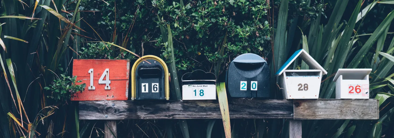 six multicolored mailboxes