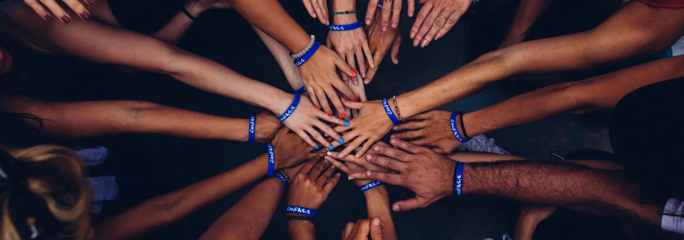 Group of people with hands together