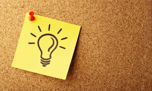 bulletin board with a drawing of a lightbulb pinned to it