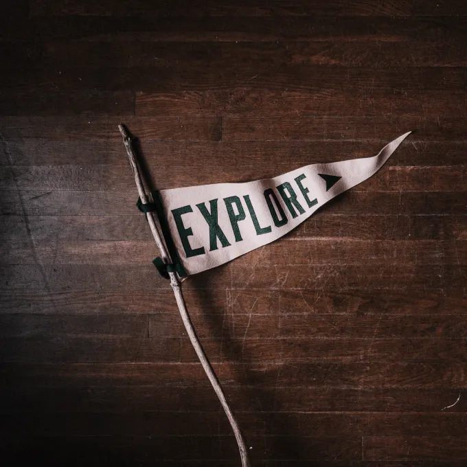 white flag with the word explore written in bold dark letters
